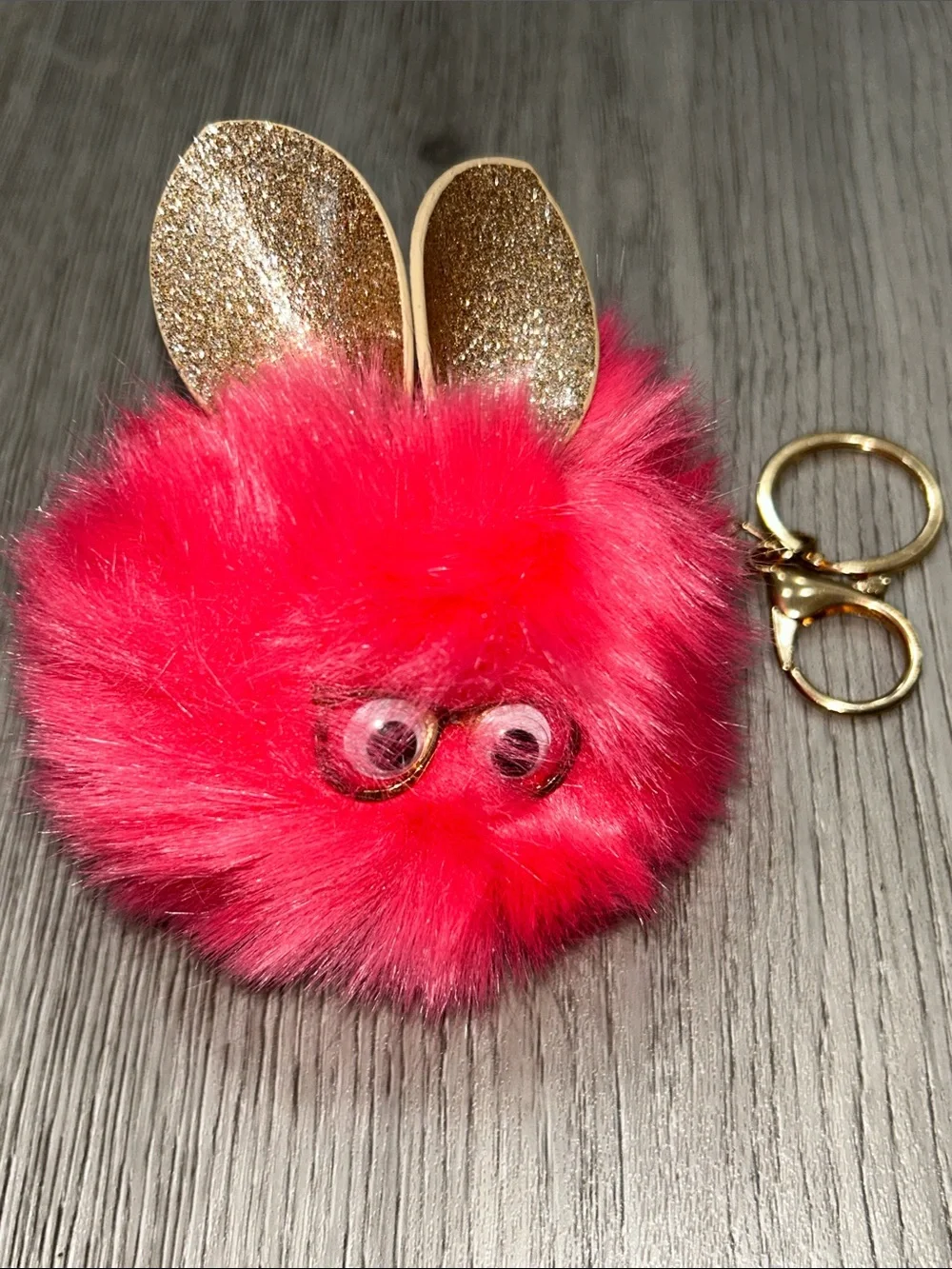 Pink Fuzzy Furby Pom Pom Keychain wearing glasses with Gold Accents